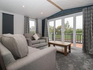 a living room with a couch and a table at Meadows Park 3 in Hull