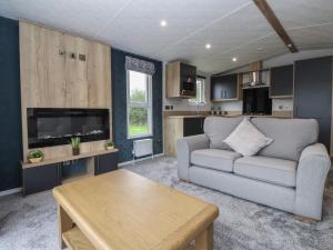 a living room with a couch and a table at Meadows Park 3 in Hull