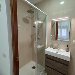 a bathroom with a glass shower and a sink at La Fragua de Domingo in Villanueva de los Infantes +34 photos