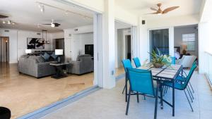 a dining room and living room with a table and chairs at 131 Mariners Club in Key Largo