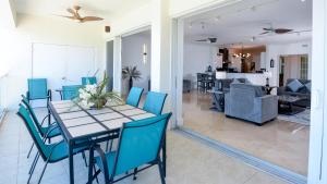 a dining room with a table and blue chairs at 131 Mariners Club in Key Largo