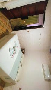 a room with a white bed with a window at Pousada Praia da Pipa in Pipa +17 photos