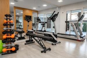 a gym with several treadmills and machines in a room at Amazon Park Hotel in Belém +14 photos