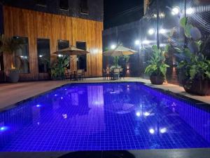 a large swimming pool with purple lights on it at Amazon Park Hotel in Belém