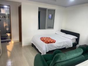 a bedroom with a bed with a red blanket on it at La bendición de sunnyvale in La Vega