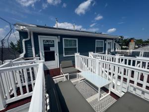 a blue house with a white railing on a balcony at Shore Oasis in Seaside Heights