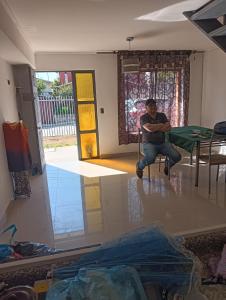 a man sitting on a chair in a room at Casa Acquarella in Viña del Mar