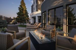 a patio with chairs and a fire pit on a building at Courtyard Casper in Casper