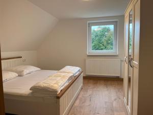 a bedroom with a bed and a window at 4-Steine-Blick, Wohnung 1 in Schöna