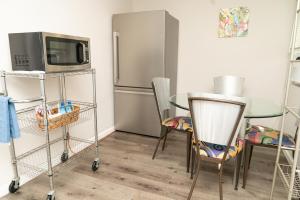 a kitchen with a table and a microwave and a refrigerator at Serene Studio Retreat in Jacksonville