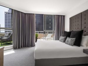 a bedroom with a large bed and a large window at Mantra 2 Bond Street in Sydney +131 photos