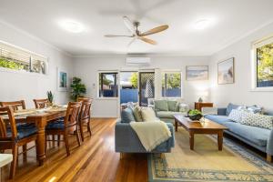 a living room with a table and a couch at Rocky Shores Hideaway in South West Rocks