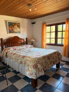 a bedroom with a bed in a room with windows at Casa cómoda en La Barra in Punta del Este