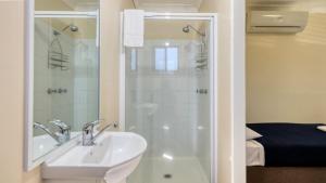 a bathroom with a sink and a shower at River Gum Tourist Park in Saint George +16 photos