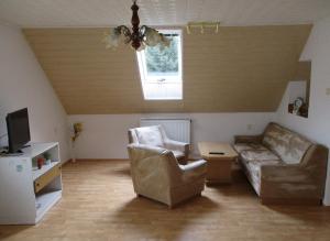 a living room with a couch and two chairs at Apartmán Eva in Crhov