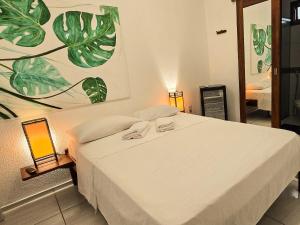 a bedroom with a bed with two towels on it at Pousada Viva Praia in Paracuru