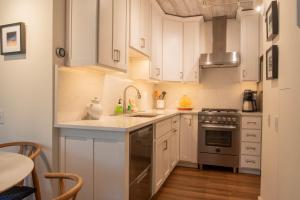 a kitchen with white cabinets and a sink and a stove at Villager Condo 1240 in Sun Valley