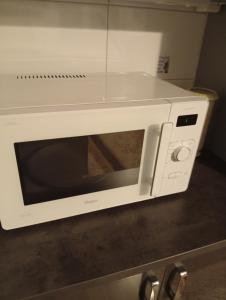 a white microwave oven sitting on top of a counter at B&BAnjanaS in Vaggeryd