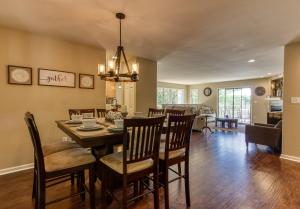 a dining room and living room with a table and chairs at Memorable "Deer & Doe" by HoneyBearCabins 4BR 3BA, Mountain View Deck, Farmhouse Decor, Fireplace, 3 Acres in Sevierville