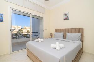 a bedroom with a large bed with a large window at Ocean Dream - Spacious Duplex with Ocean View, Astonishing Sunset - 4 Bedrooms with Balcony - WIFI, IPTV in Tangier +57 photos