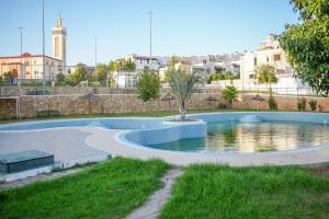 a swimming pool with a palm tree in a park at Ocean Dream - Spacious Duplex with Ocean View, Astonishing Sunset - 4 Bedrooms with Balcony - WIFI, IPTV in Tangier