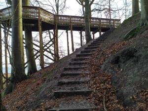 a set of stairs leading up to a wooden bridge at 6 person holiday home in Juelsminde-By Traum in Sønderby