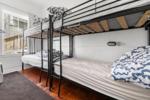 a bedroom with two bunk beds and a window at Worldwide Backpackers in Wellington +40 photos