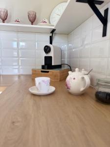 a tea pot and a teapot on a table in a kitchen at Warmia Domek Bukowy in Woryty +38 photos