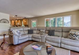 a living room with a couch and a table at Memorable "Deer & Doe" by HoneyBearCabins 4BR 3BA, Mountain View Deck, Farmhouse Decor, Fireplace, 3 Acres in Sevierville +31 photos