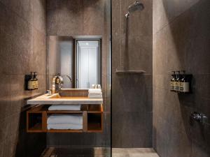 a bathroom with a sink and a shower at Peppers Gallery Hotel in Canberra