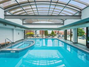 a large swimming pool with a glass ceiling at Mantra on Russell in Melbourne