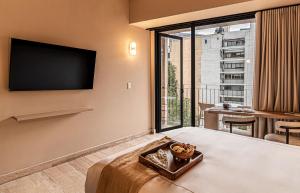 a hotel room with a bed and a large window at Kukun Marsella Juarez in Mexico City