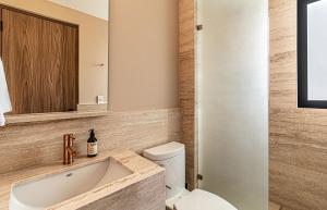 a bathroom with a sink and a toilet and a mirror at Kukun Edition Marsella Juarez in Mexico City