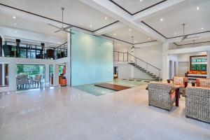 a large living room with a glass wall at Ulysses Rainforest Retreat in Mossman
