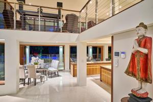a living room and dining room with a statue of a woman at Ulysses Rainforest Retreat in Mossman +21 photos
