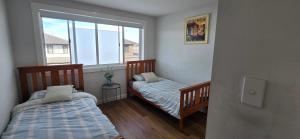 Postel nebo postele na pokoji v ubytování Spacious Famiy Living in the Heart of Marsden Park