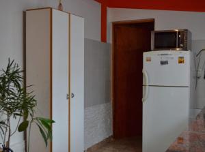 a white refrigerator with a microwave on top of it at Departamento Quetro in Trevelin