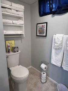 a bathroom with a white toilet and towels at Sunny Days! Room for All and Pet Friendly in Pocatello +26 photos