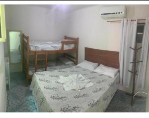 a bedroom with two bunk beds in a room at Pousada Aconchego in Aracaju