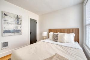 ein Schlafzimmer mit einem großen Bett mit weißen Wänden in der Unterkunft Stay Portland - La Casa Burnside -Local Eateries -Shops - Bars in Portland + 23 Fotos