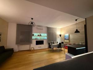 a living room with a table and a dining room at Manno House in Genova
