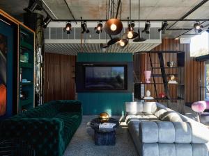 a living room with a couch and a tv at Tribe Perth Kings Park in Perth