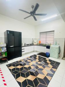 a kitchen with a black refrigerator and a checkered floor at Little Home by Arissa, Residensi Prima Afamosa in Kampong Pulau Sebang