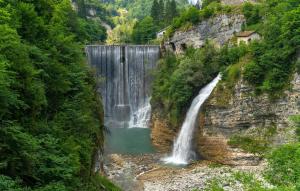 a waterfall in the middle of a mountain at Gorgeous Apartment In Lamon With Wifi in Lamon