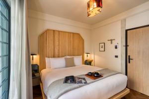 a bedroom with a bed with a tray on it at Rodona Hotel in Mexico City