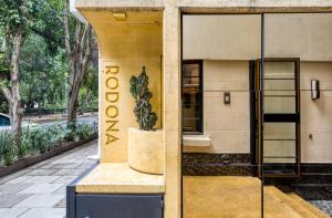a statue of a cactus in front of a building at Rodona Hotel in Mexico City