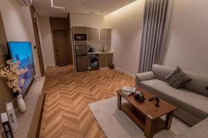 a living room with a couch and a table at فندق نخبة العارض in Riyadh +17 photos