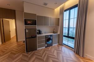 a kitchen with a washer and dryer in a room at فندق نخبة العارض in Riyadh +18 photos