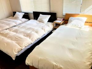 Ένα ή περισσότερα κρεβάτια σε δωμάτιο στο ペットと泊まれる一棟貸し 海の駅九十九里まで徒歩15分 はうす41マイルズ