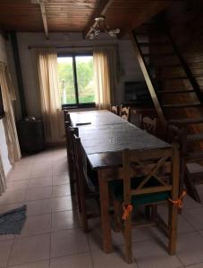 a wooden table and chairs in a room at Sampa Pacha Complejo de Cabañas in Bialet Massé